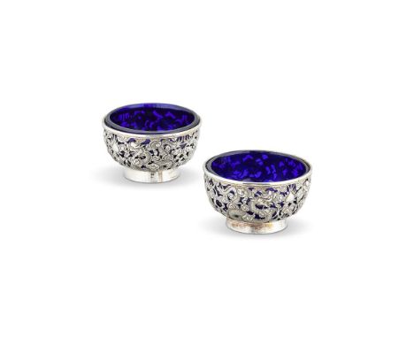 A PAIR OF CHINESE EXPORT SILVER CIRCULAR SALT CELLARS BY WANG HING & CO.HONG KONG, CANTON & SHANGHAI (WH, 90, CHOP MARK), FL.