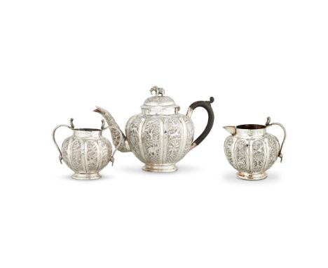 A NORTH INDIAN OR PAKISTANI LOBED SPHERICAL THREE PIECE TEA SERVICEUNMARKED, MID 20TH CENTURYThe tea pot with an elephant fin
