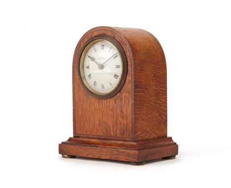AN OAK MANTLE CLOCK
Retailed by W.Grenwood, Leeds &amp; Huddersfield, early-mid 20th Century, with domed cross-banded case, t