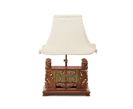 AN INDONESIAN CARVED TABLE LAMP
With adjustable shade, the base carved with dragons, lions and and foliate motifs
25cm high e