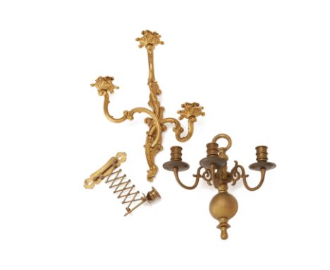 A GROUP OF BRASS WALL APPLIQUES/CANDLE HOLDERS
Comprising: a foliate rococo style gilt brass wall light; a brass three branch
