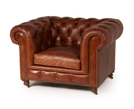 A TIMOTHY OULTON LEATHER CHESTERFIELD TYPE ARMCHAIR
Leather upholstered, button back and sides, on brass casters
TIMOTHY OULT