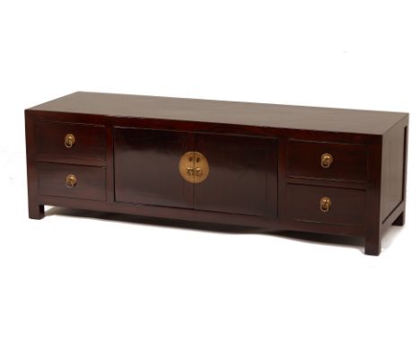 A BLACK LACQUERED LOW SIDE CABINET
With four drawers flanking two shelves, and ring handles, the interior removed at the back