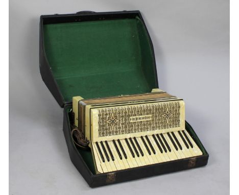 A Vintage Hohner Tango III Piano Accordion in Carrying Case 