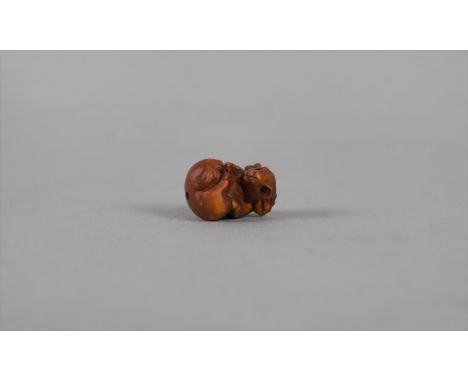 A Small Carved Wooden Netsuke in the Form of a Mouse 