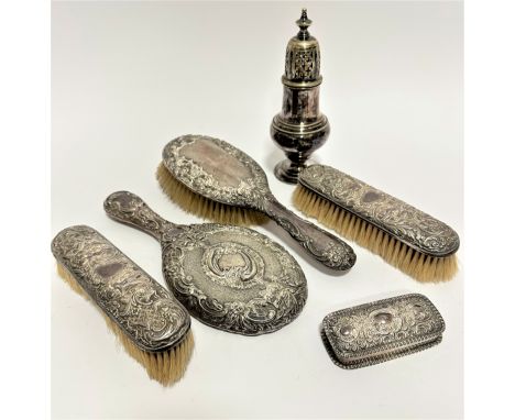 A Birmingham silver backed chased hairbrush, a Chester silver backed chased hand mirror, a pair of London silver backed cloth