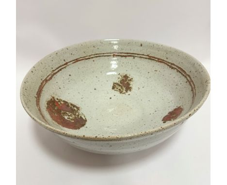 An exceptionally large pottery bowl, with internal brown double ring and patches of iron oxide, signed indistinctly verso (18