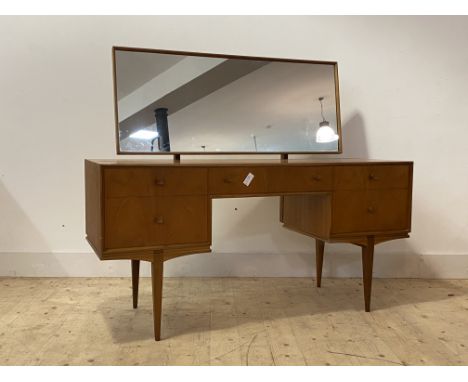 McIntosh, A mid century teak dressing table, the swing mirror over one long and four short drawers, raised on square tapered 