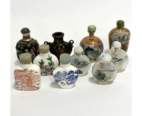 Four various ceramic modern Chinese snuff bottles with transfer printed and enamelled decoration, a cast metal snuff bottle -