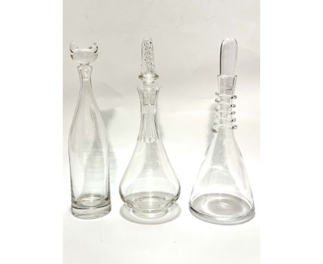 An Orrefors crystal cylinder decanter with cats head style moulded stopper, (h 37cm x 8cm), signed to base,  a baluster thumb
