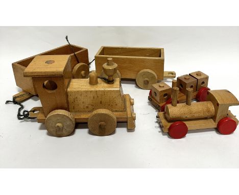 A treen child's model steam engine with two carriages and a smaller treen steam engine with carriage with three blocks and re