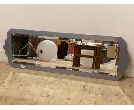A contemporary wall hanging mirror, the bevelled plate within a polished steel frame, 141cm x 46cm
