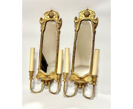 A pair of gilt wood wall appliques with shell shaped surmount and mirror panelled backs with twin branches,  (56cm x 21cm)