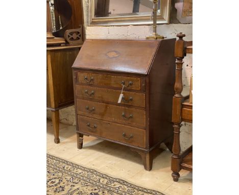An Edwardian inlaid and satinwood banded mahogany bureau, the fall front enclosing fitted interior, over four graduated drawe