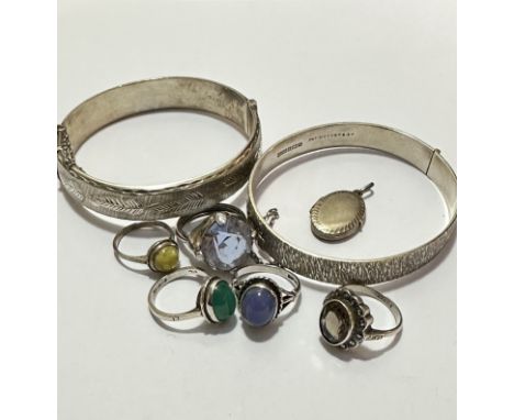 Five various white metal and silver rings, one set oval cabuchon green stone, another with lavender coloured stone, a citrine