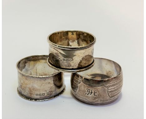 A Birmingham silver napkin ring and a Birmingham silver engraved napkin ring with engraved initials JH  (50.9g) (3) 