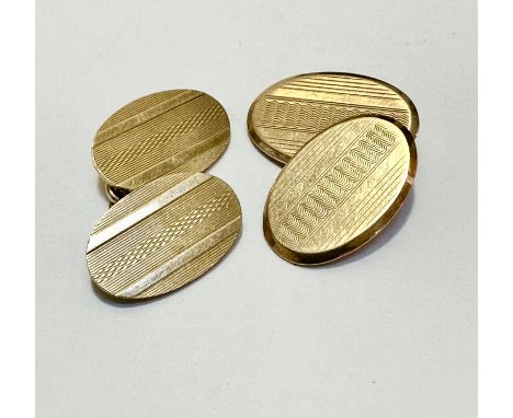 Two 9ct gold engine turned decorated oval sleeve links, (L 2cm x 1cm) weighs 8.4g 