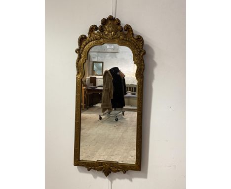 An Ornate 18th century style gilt composition framed wall hanging mirror, with scrolling pediment and acanthus leaf to base, 