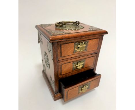 A Chinese 1920's cherrywood miniature casket with brass hinged handle to top, with bat engraved corners, fitted three drawers