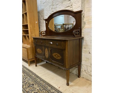 An Edwardian inlaid mahogany mirror back sideboard, with two drawers and two cupboards raised on square tapered supports with