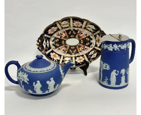 A Wedgwood Royal blue Jasperware teapot of squat form (13cm x 22cm), a similar decorated hot water pot, (16cm x 9cm), and a R