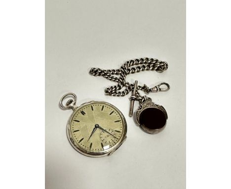 An Art Deco Continental white metal open faced pocket watch with silvered stylised engine turned decorated dial, with baton h