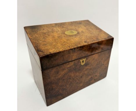 An Edwardian burr walnut slope-front stationary box, the hinged top enclosing a fitted interior with brass escutcheon and pla