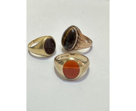 A 14ct gold Tiger's Eye oval cabuchon dress ring, size O, weighs 5.4g and a 9ct gold Agate mounted gentleman's style signet r