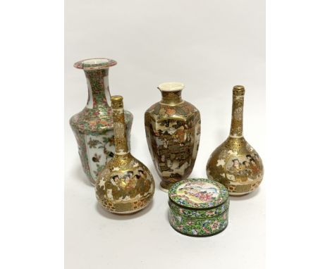 A pair of Japanese bottle neck Satsuma vases decorated with figures enclosed within gilt reserves, complete with tops, one wi