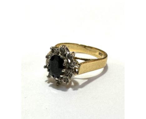 An 18ct gold sapphire and diamond cluster ring, the oval sapphire approximately .25ct, with a surround of ten diamond points,