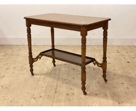 An Edwardian oak side table, the top with moulded edge and canted corners over ring turned supports united by a tray top unde