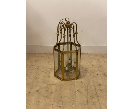 A Gilt brass hexagonal hall lantern, with inset bevelled plates enclosing four branches, H75cm