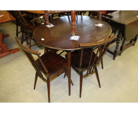 Oval ercol table and four stick back chairs