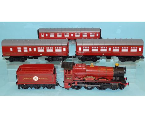 Lionel, a G/1 gauge Harry Potter "Hogwarts Castle" 4-6-0 battery-powered locomotive, tender and two coaches, an O gauge coach