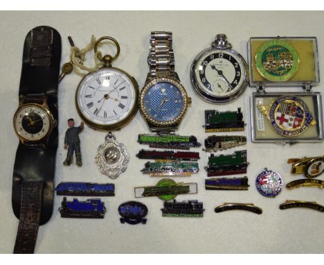 An Ingersoll Triumph wrist watch, a Tevise wrist watch, two pocket watches, various railway engine badges, etc. 