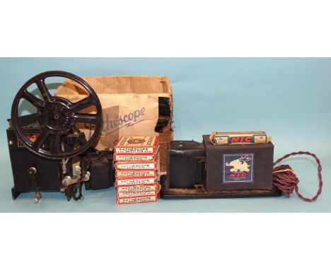 An NIC projector c1940's, of tinplate and card construction, with one paper roll-film, "La Vengeance des Souris" and a Pathés