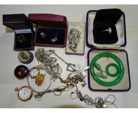 A green glass jade-effect bangle, two gold-plated watches, a silver charm bracelet, a paste brooch and other items. 