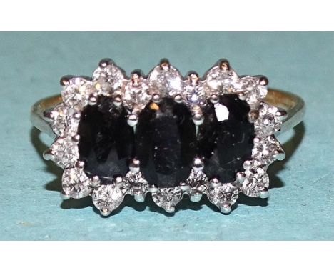 A 9ct gold ring set a cluster of three sapphires and synthetic white stones, size R, 2.7g. 