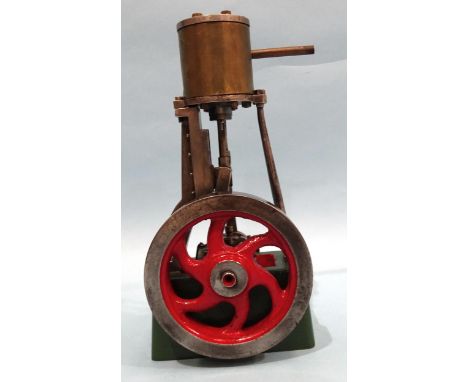 A single-piston vertical stationary engine with flywheel, unmarked, 19.5cm. 