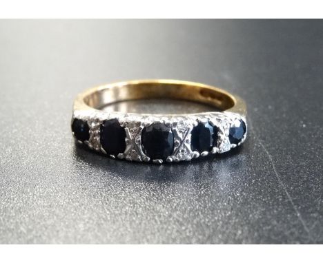 SAPPHIRE AND DIAMOND RINGthe five graduated sapphires separated by small diamonds, on nine carat gold shank with scroll decor