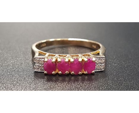 RUBY AND DIAMOND RINGthe central four oval cut rubies with four diamonds to each shoulder, on nine carat gold shank, ring siz