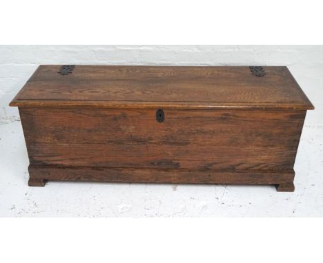 OAK COFFERwith a moulded lift up lid with decorative false hinges, side carrying handles and standing on bracket feet, 127cm 