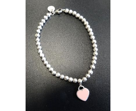 TIFFANY & CO. MINI HEART TAG SILVER BEAD BRACELETthe heart tag with 'Return to Tiffany' engraving to one side and pink enamel