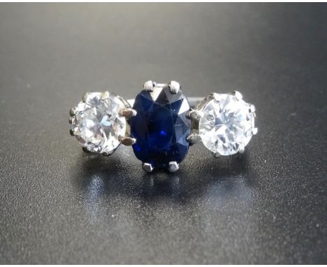 EXCEPTIONAL SAPPHIRE AND DIAMOND THREE STONE RINGthe central oval cut sapphire approximately 1.5cts, flanked by round brillia