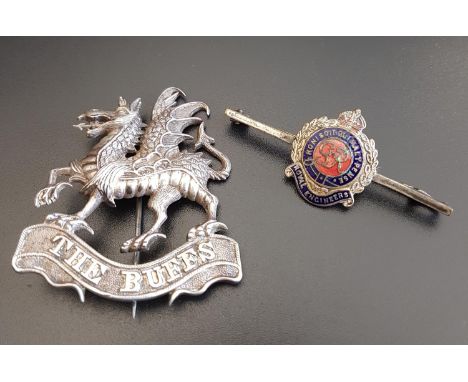 UNMARKED SILVER 'BUFFS' DRAGON BROOCHthe dragon standing on a ribbon marked 'The Buffs'; together with an enamel decorated Ro