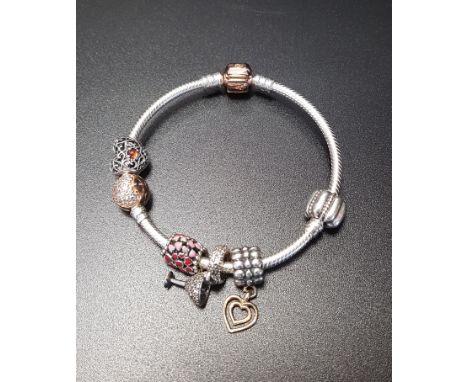 PANDORA MOMENTS SILVER CHARM BRACELETwith rose clasp, four Pandora charms including an enamel decorated heart and a cocktail 