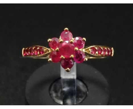 RUBY CLUSTER RINGthe central ruby in six ruby surround and with further rubies to the shoulders, on nine carat gold shank, ri