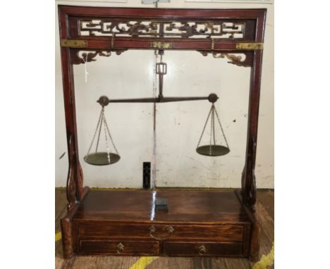 A set of Chinese apothecary weighing scales, the hardwood stand with brass weighing scales. 95cm x 75cm x 30cm 