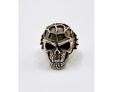 A silver 'knuckleduster' skull ring. 