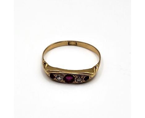 An 18ct yellow gold, diamond, and ruby ring, set with a larger round-cut ruby, two old-cut diamonds, and two smaller rubies, 